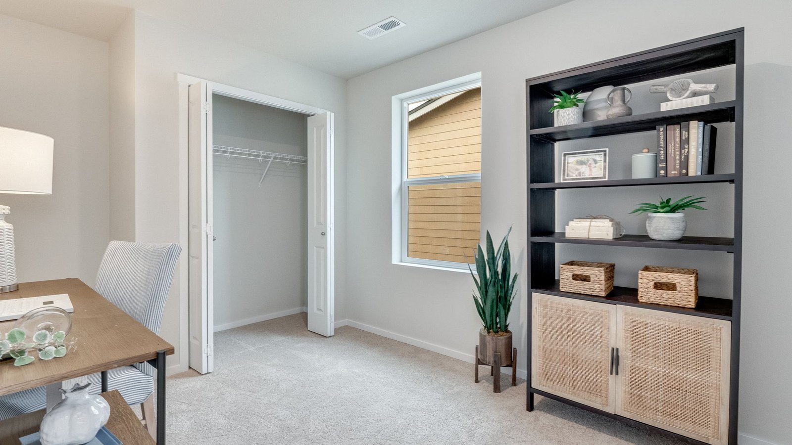 Bedroom with wall-to-wall carpet and a closet