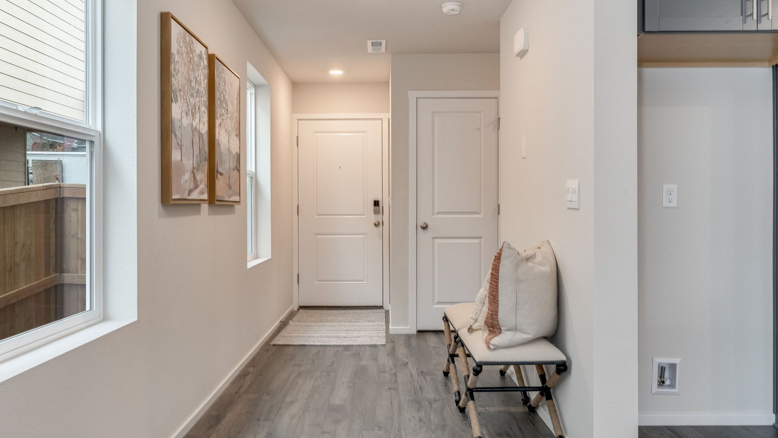 Entryway with a coat closet and laminate flooring