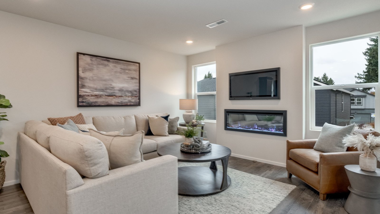 Great room with laminate flooring and an electric fireplace