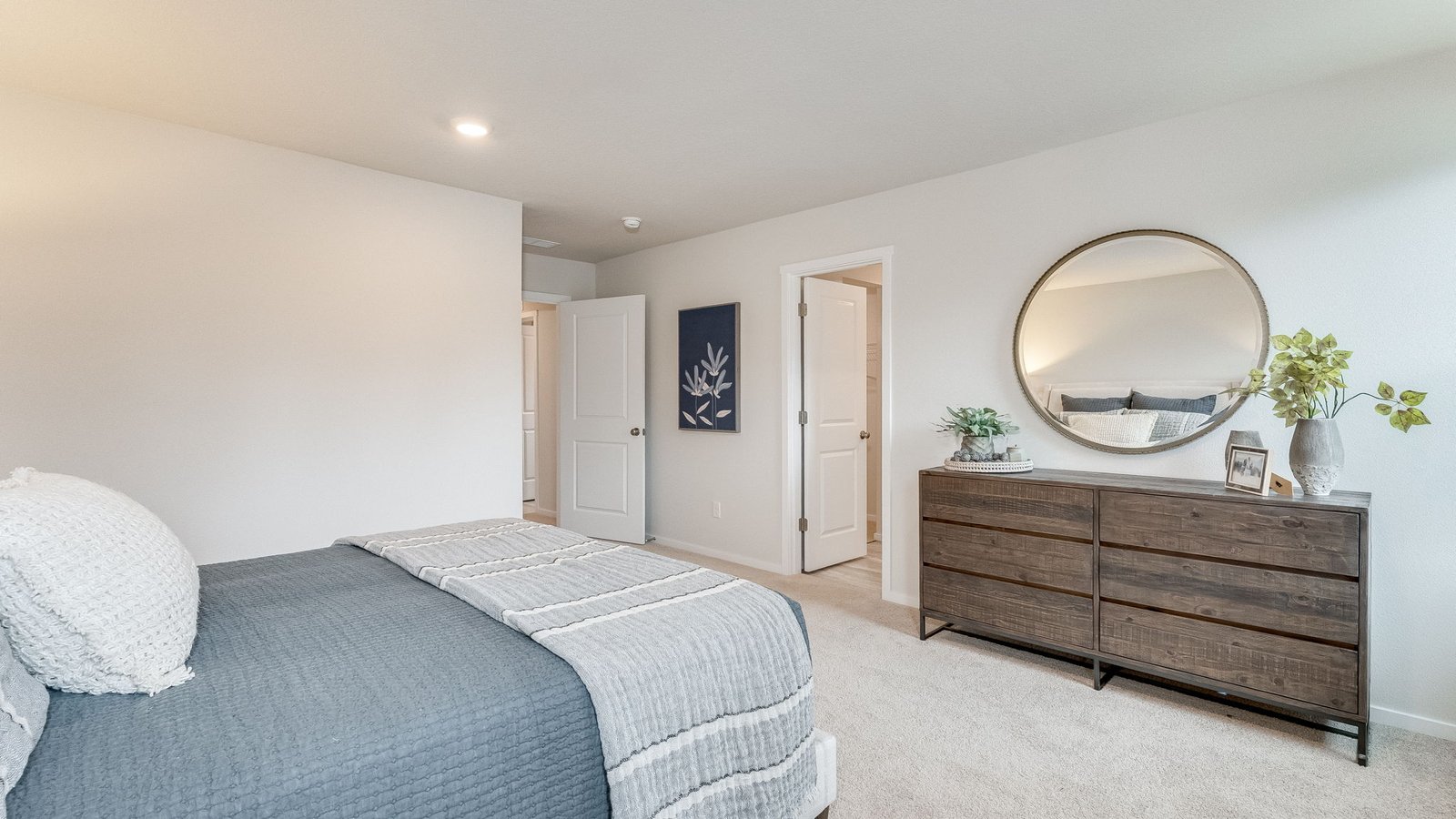 Primary bedroom with wall-to-wall carpet, a walk-in closet and an attached bathroom