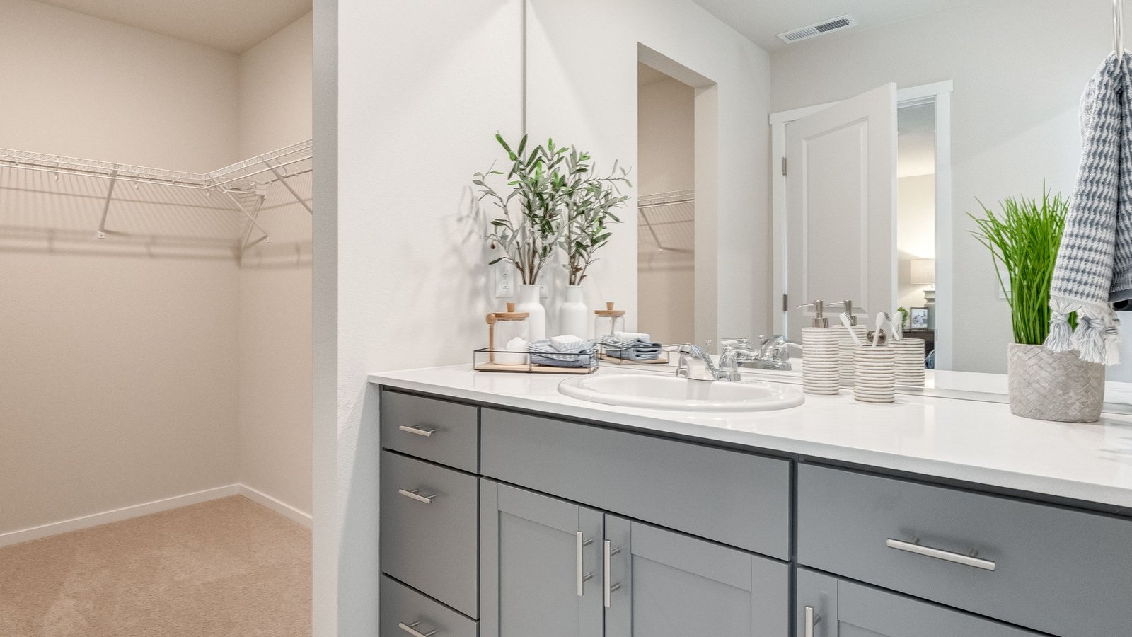 Primary bathroom with quartz counters and a walk-in shower