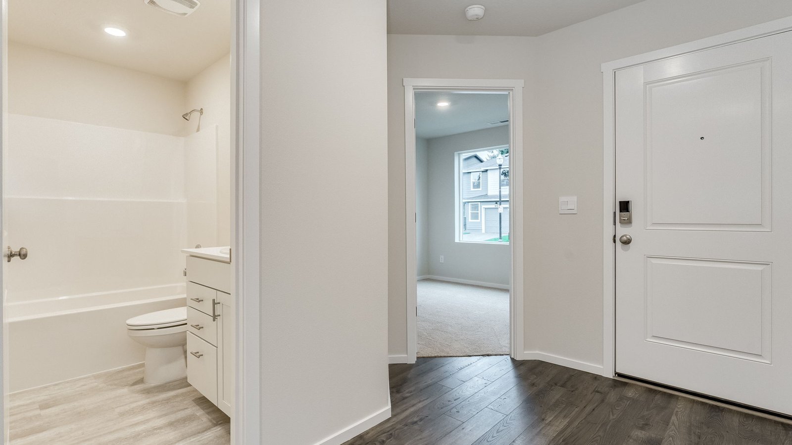 Entryway with a coat closet and laminate flooring