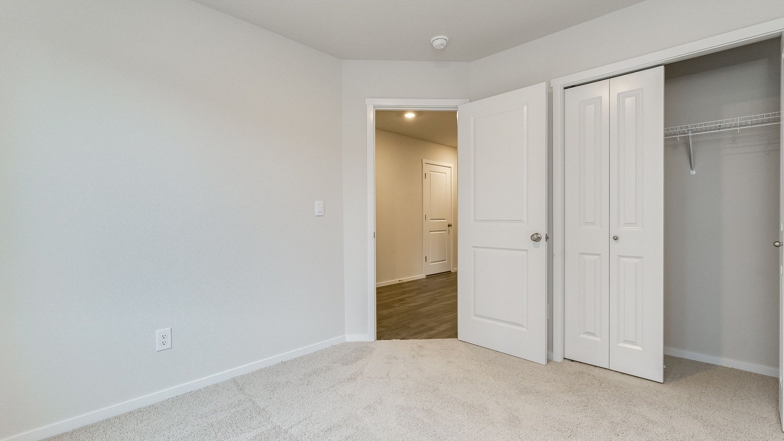 Bedroom with wall-to-wall carpet and a closet