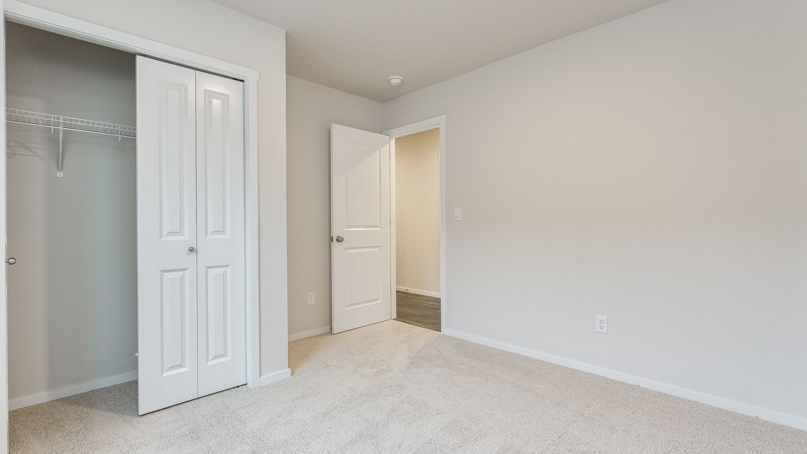 Bedroom with wall-to-wall carpet and a closet