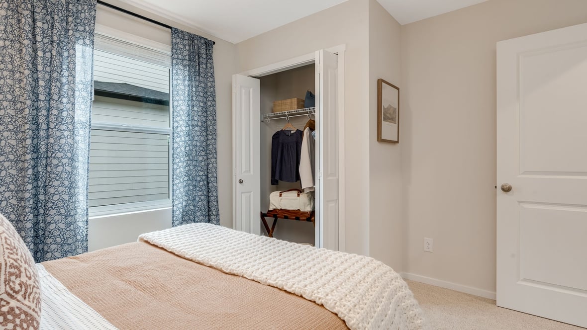 Bedroom with wall-to-wall carpet and a closet