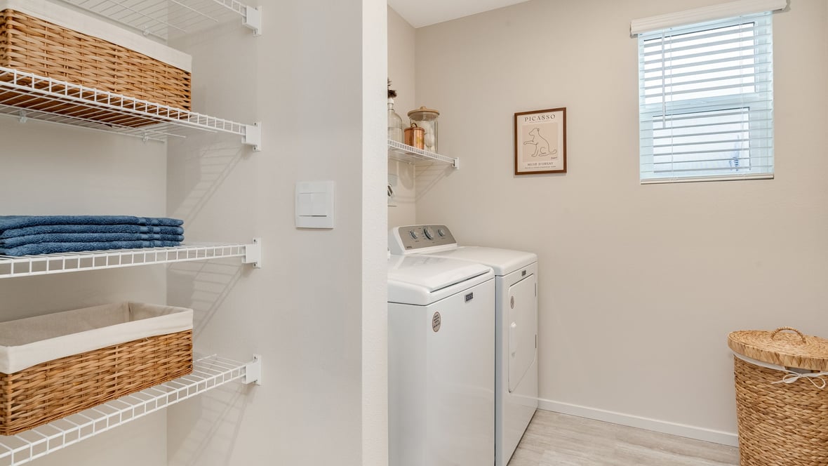 Laundry room with wire shelves and washer and dryer hookups