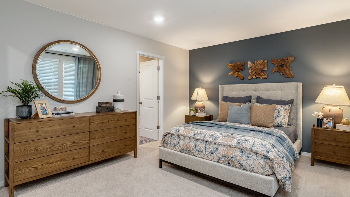 Primary bedroom with wall-to-wall carpet, a walk-in closet and an attached bathroom