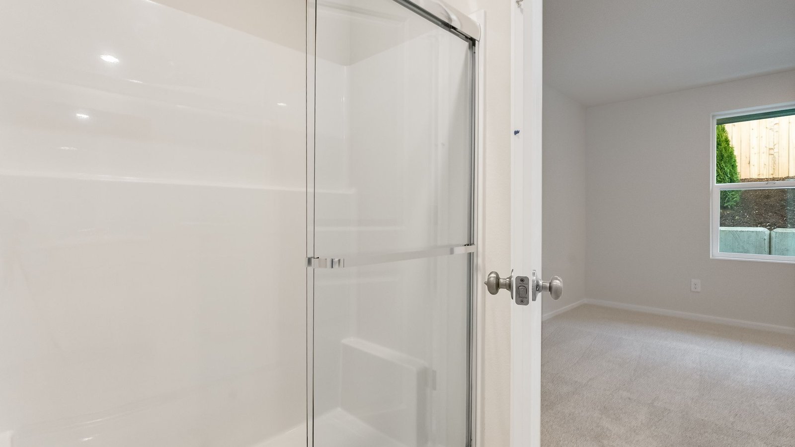 Primary bathroom with quartz counters and a walk-in shower