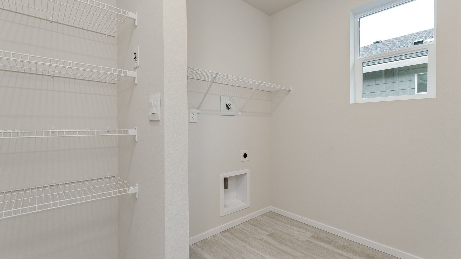 Laundry room with wire shelves and washer and dryer hookups
