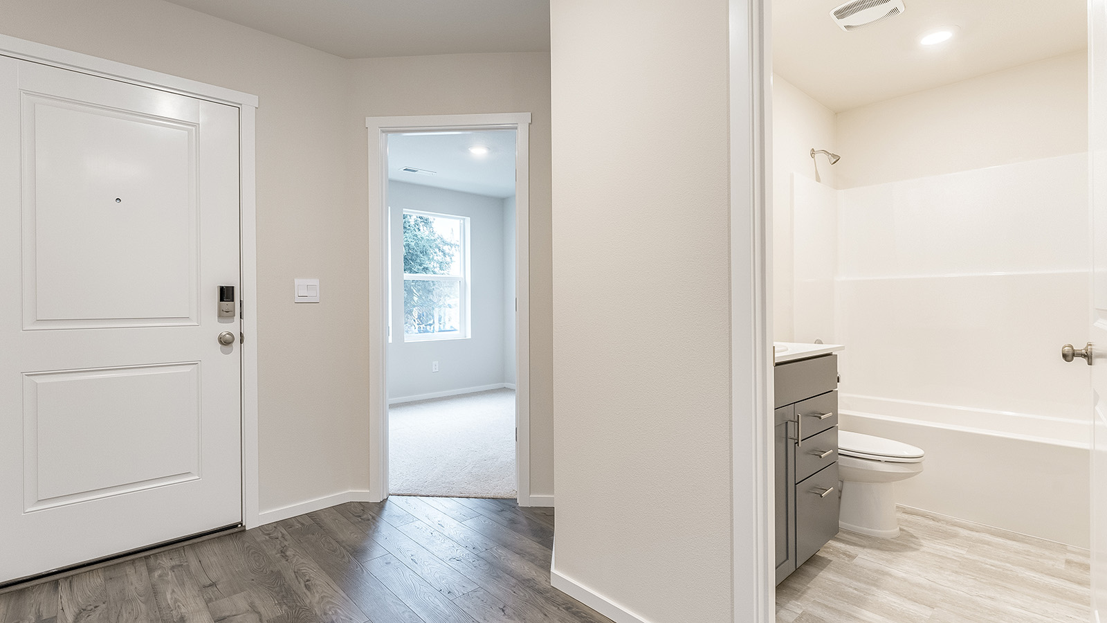 Entryway with a coat closet and laminate flooring