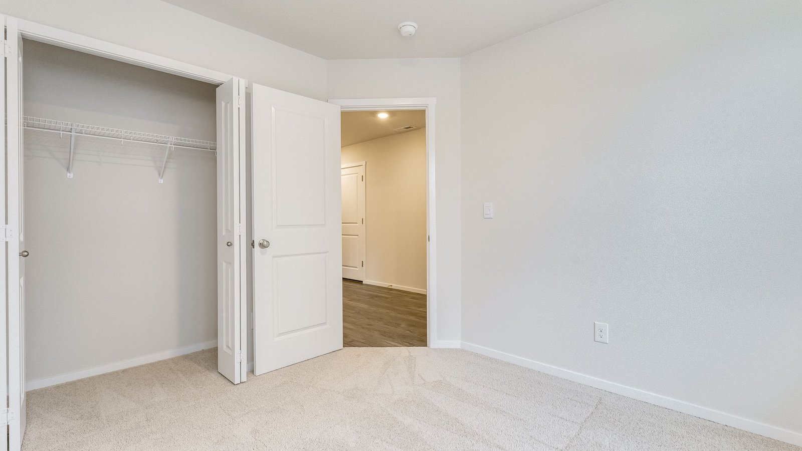 Bedroom with wall-to-wall carpet and a closet