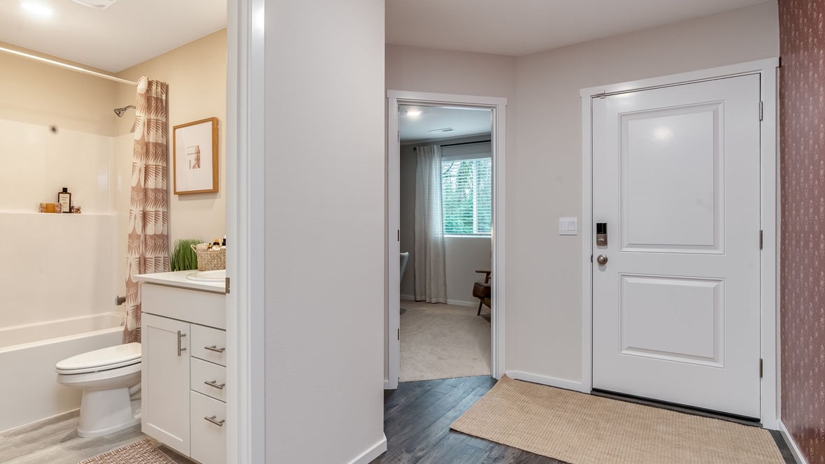 Entryway with a coat closet and laminate flooring
