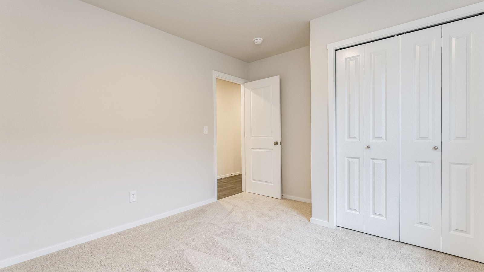 Bedroom with wall-to-wall carpet and a closet