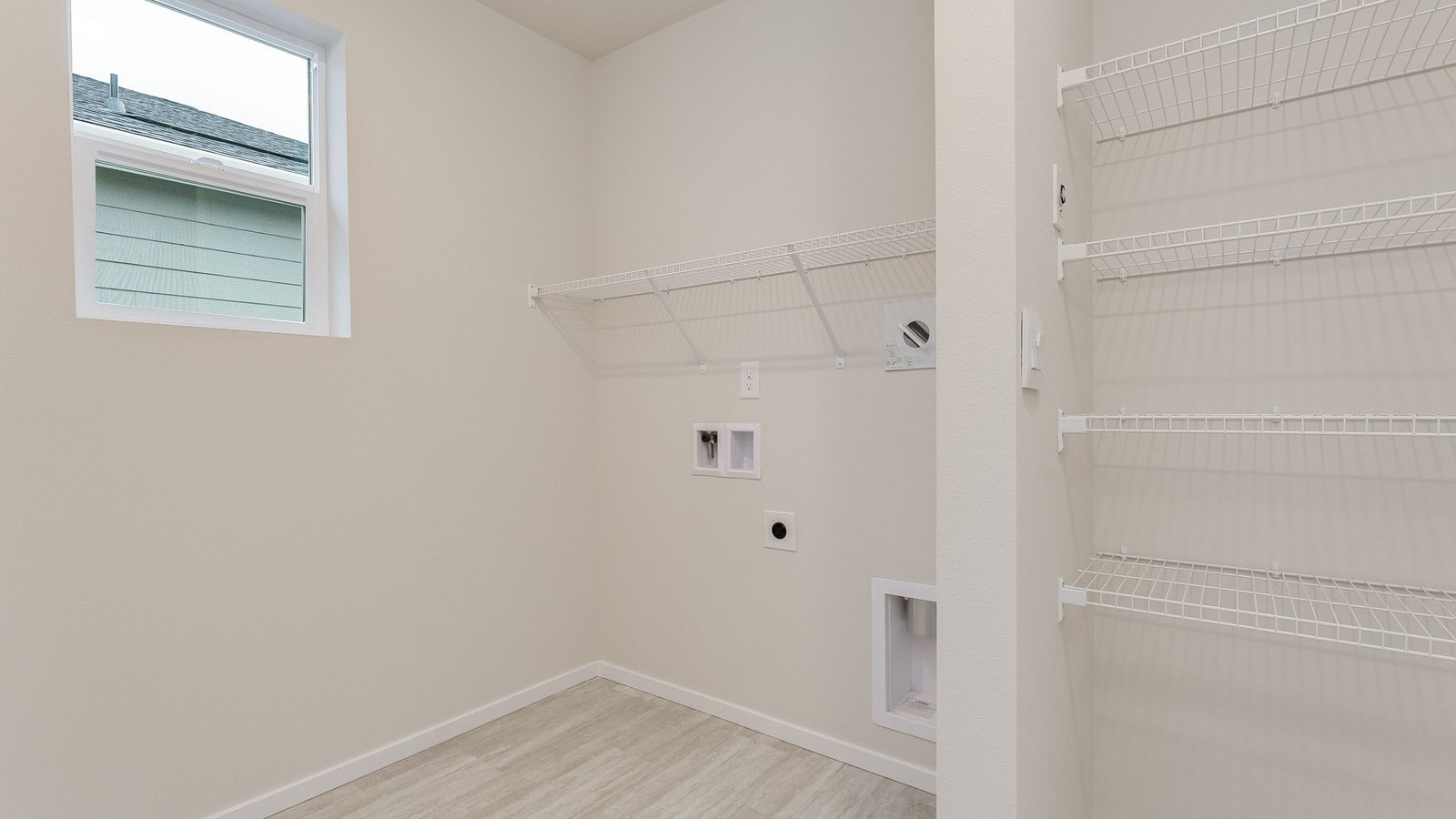 Laundry room with wire shelves and washer and dryer hookups