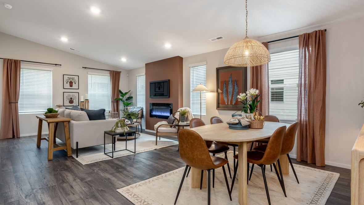 Great room with laminate flooring and an electric fireplace and vaulted ceilings