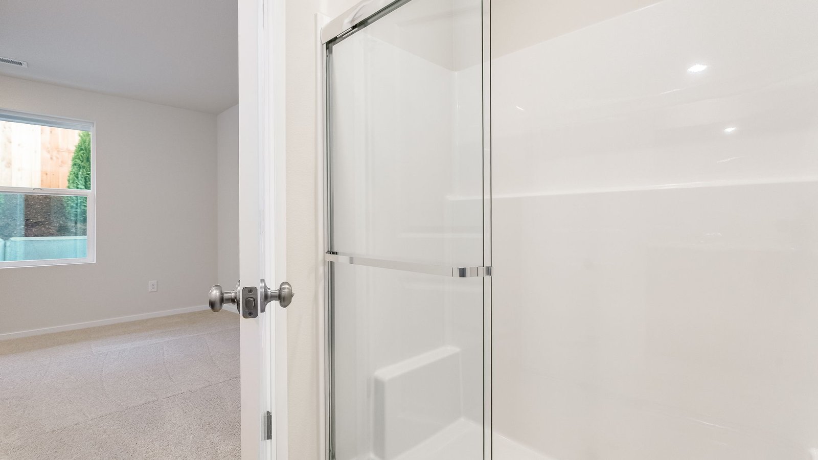 Primary bathroom with quartz counters and a walk-in shower