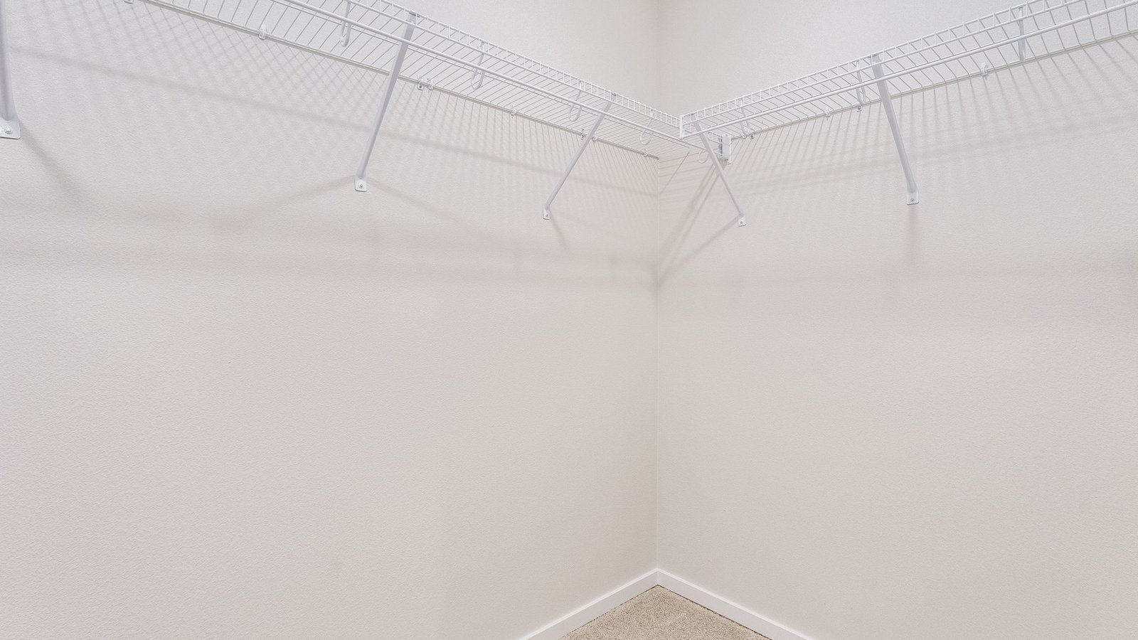 Primary bedroom walk-in closet with wire shelves