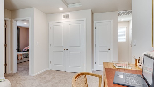 Laundry closet with wire shelves and washer and dryer hookups