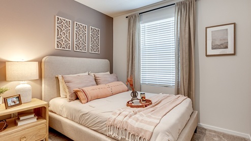 Guest bedroom with wall-to-wall carpet and a closet