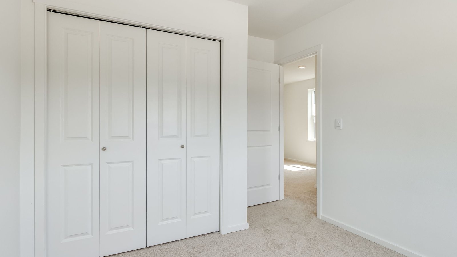 Bedroom with wall-to-wall carpet and a closet