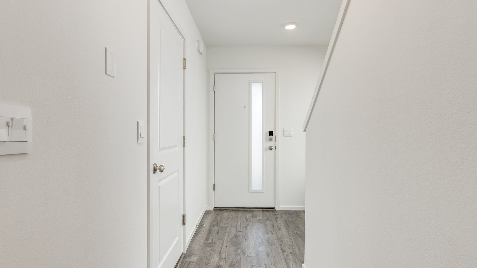 Entryway with a coat closet and laminate flooring