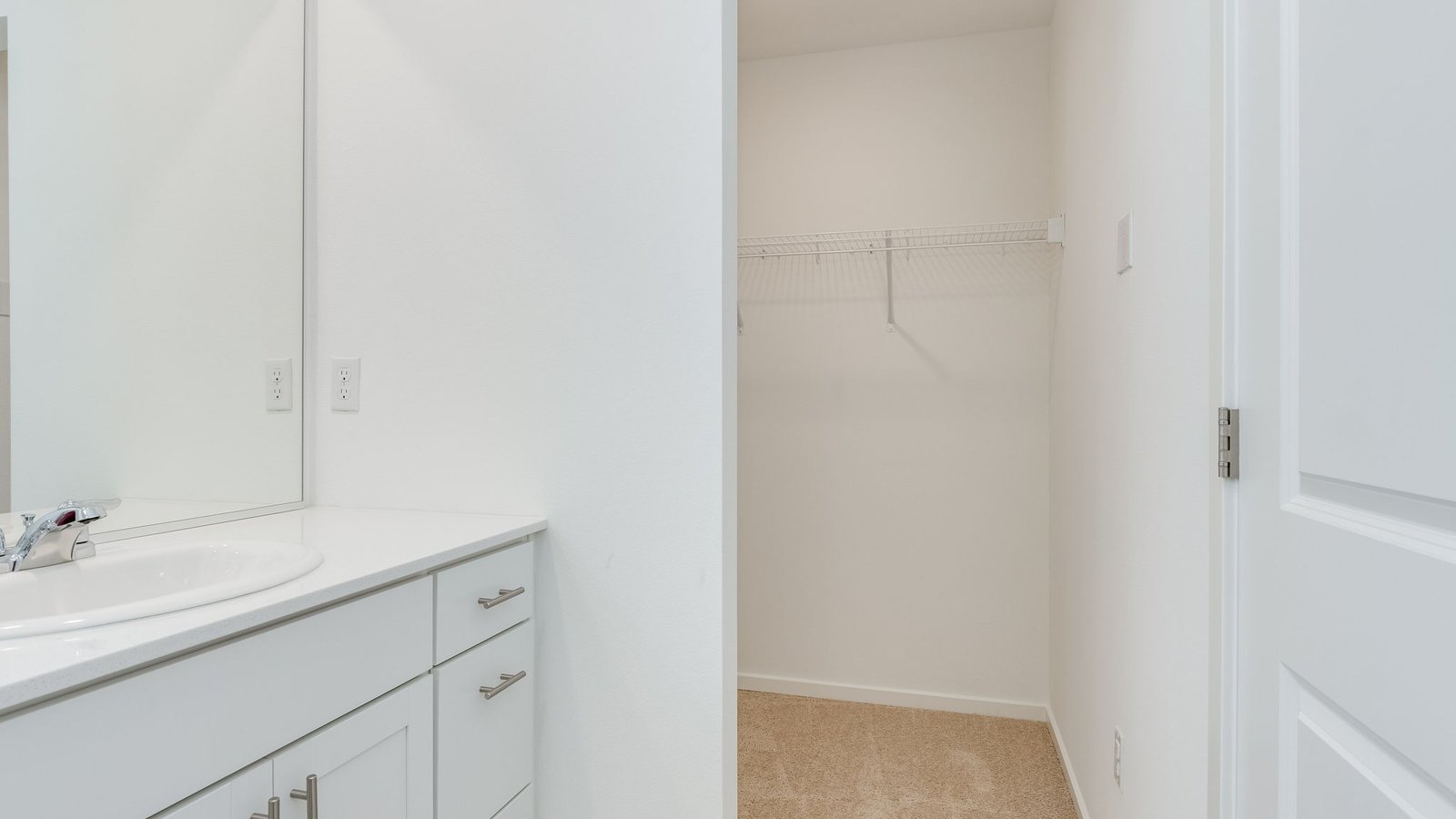 Primary bathroom with quartz counters and a walk-in shower