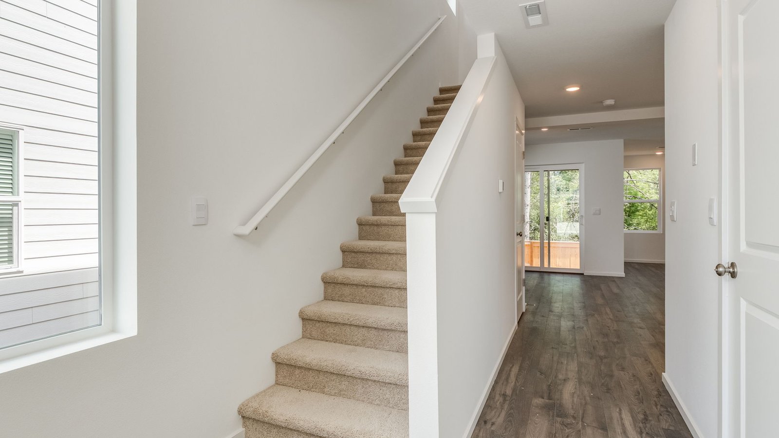 Entryway with a coat closet and laminate flooring