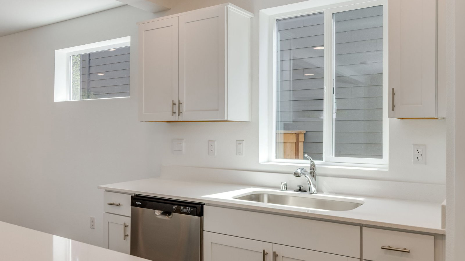 Kitchen with shaker cabinets, quartz counters, stainless steel appliances, pantry, and an island with a breakfast bar