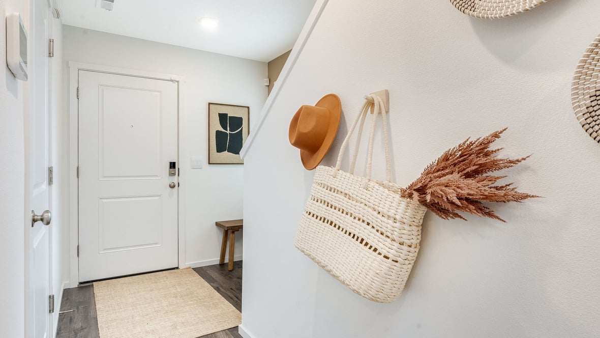 Entryway with a coat closet and laminate flooring