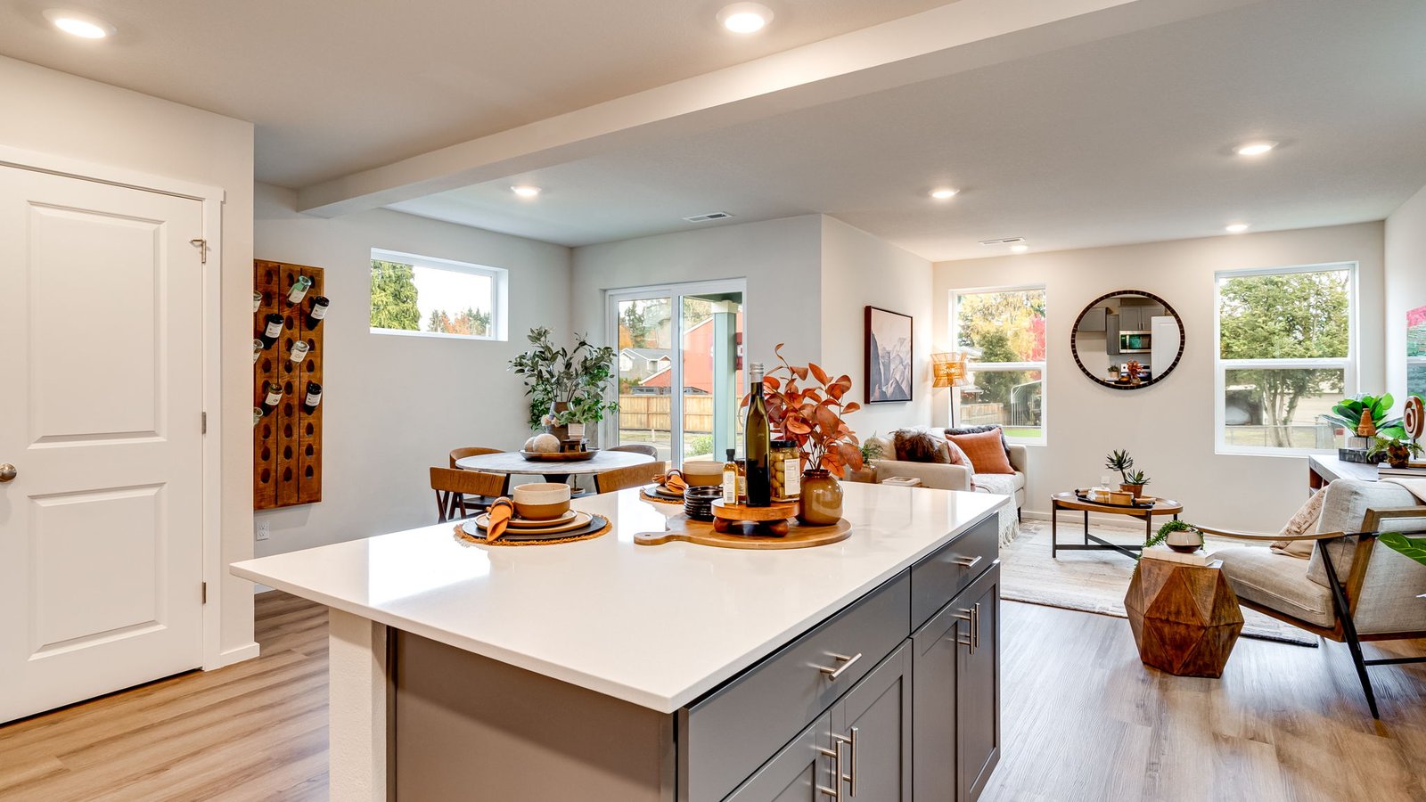 Kitchen with shaker cabinets, quartz counters, stainless steel appliances, pantry, and an island with a breakfast bar