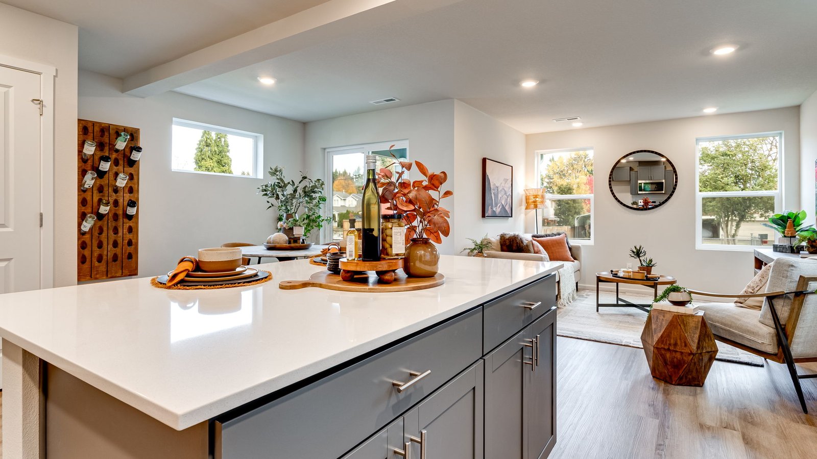 Kitchen with shaker cabinets, quartz counters, stainless steel appliances, pantry, and an island with a breakfast bar