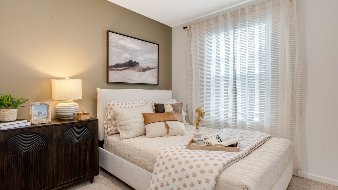 Guest bedroom with wall-to-wall carpet and a closet