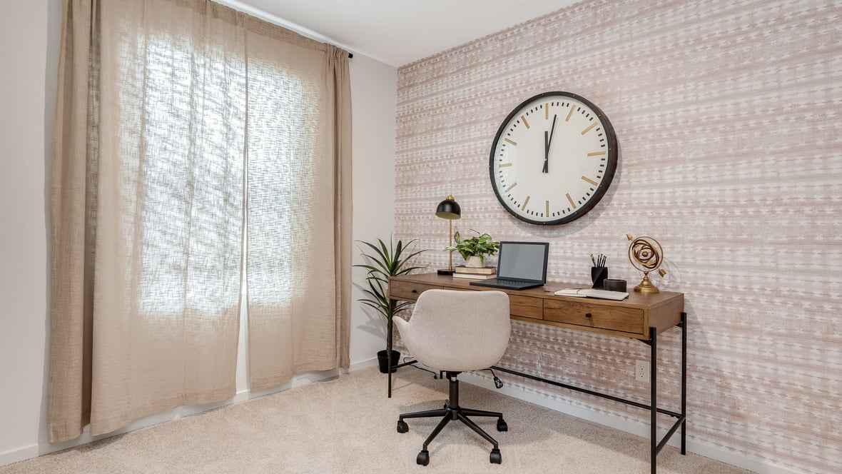 Bedroom staged as an office with wall-to-wall carpet and a closet