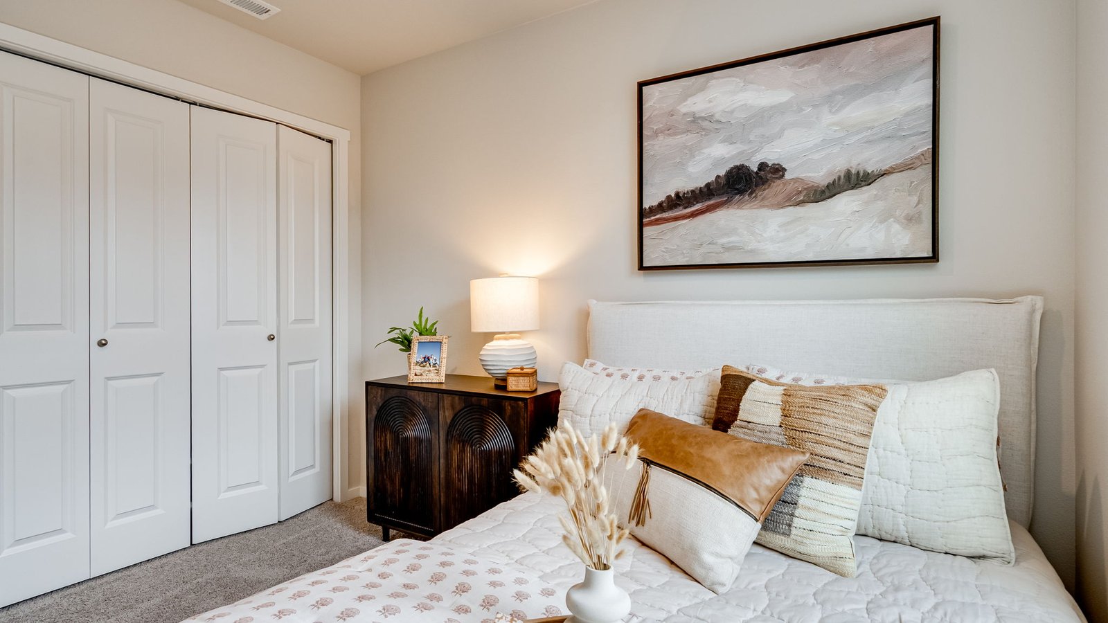 Bedroom with wall-to-wall carpet and a closet