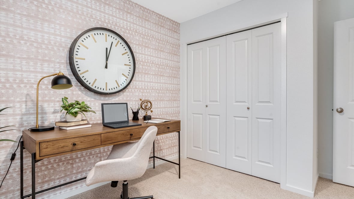 Bedroom staged as an office with wall-to-wall carpet and a closet