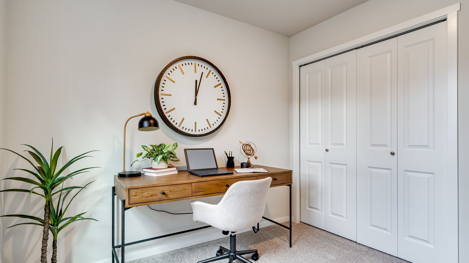 Bedroom with wall-to-wall carpet and a closet