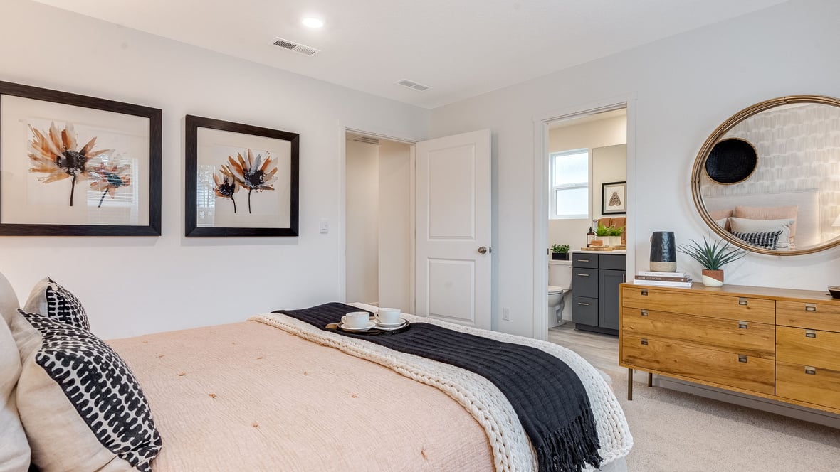 Primary bedroom with wall-to-wall carpet, a walk-in closet and an attached bathroom