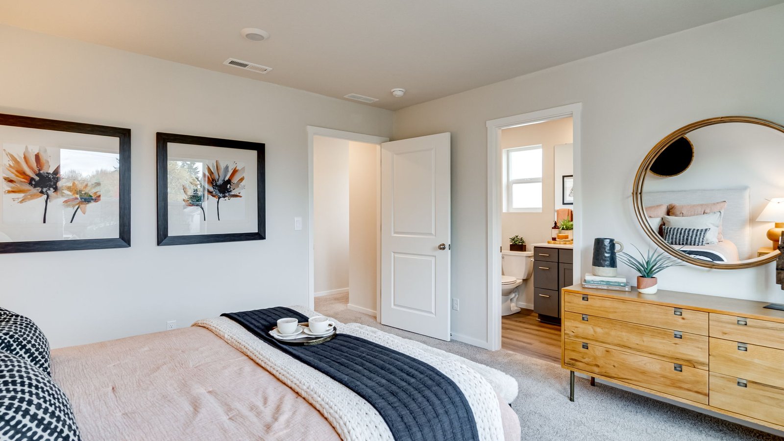 Primary bedroom with wall-to-wall carpet, a walk-in closet and an attached bathroom