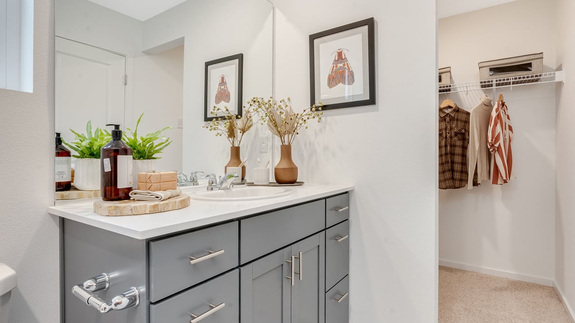 Primary bathroom with quartz counters and a walk-in shower