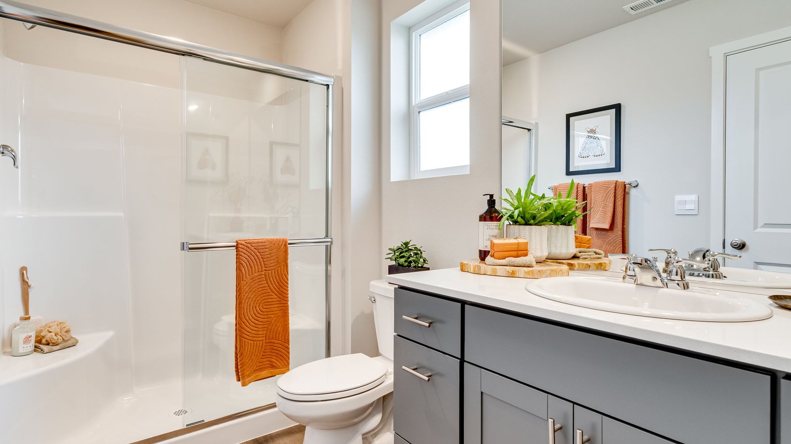 Primary bathroom with quartz counters and a walk-in shower