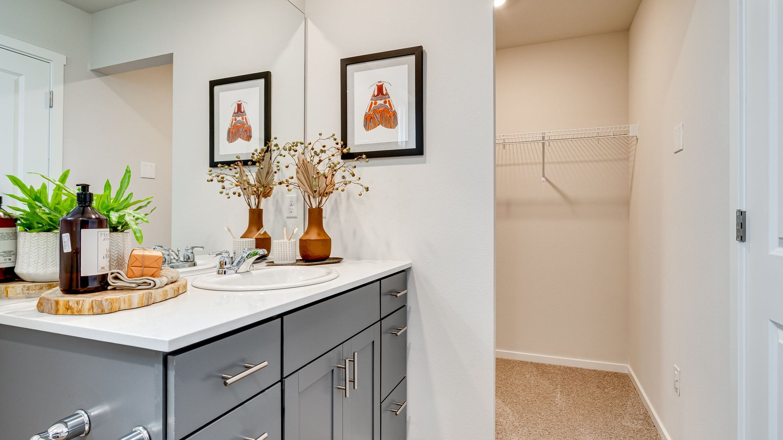 Primary bathroom with quartz counters and a walk-in shower