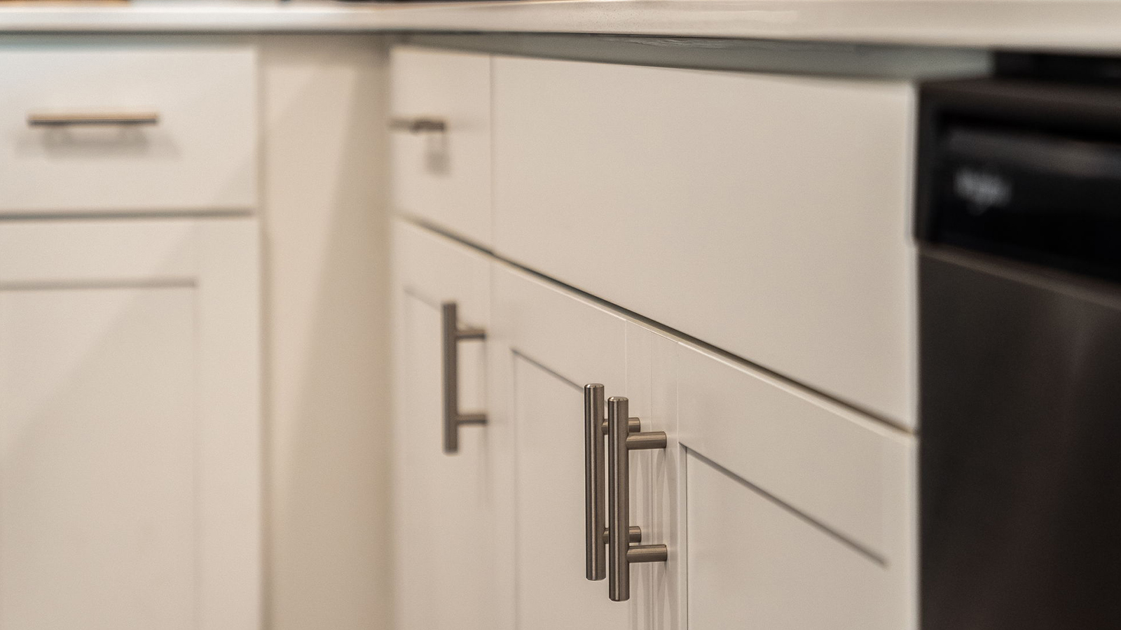Close-up on a white cabinet with chrome pulls