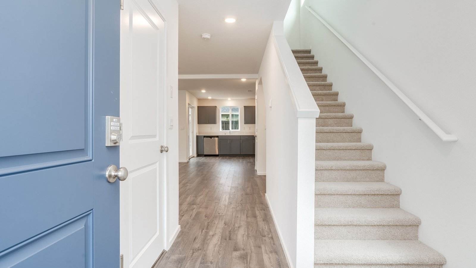 Entryway with a coat closet and laminate flooring