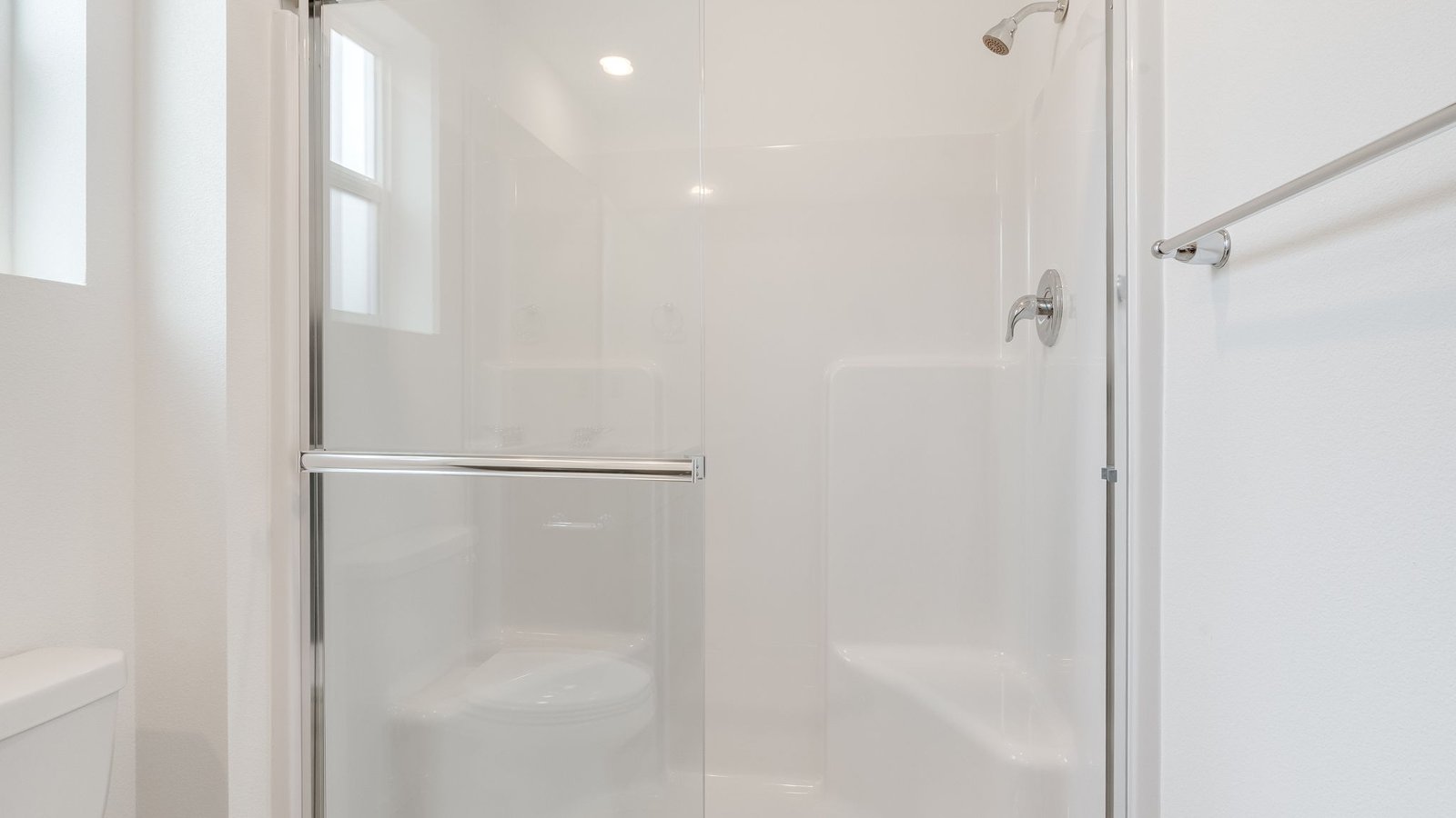 Primary bathroom with quartz counters and a walk-in shower