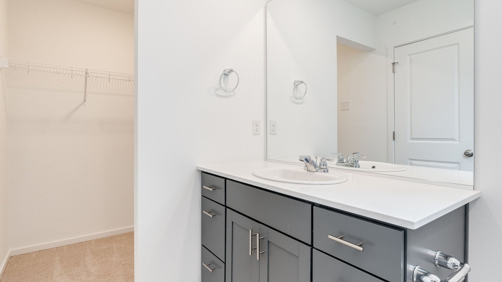 Primary bathroom with quartz counters and a walk-in shower