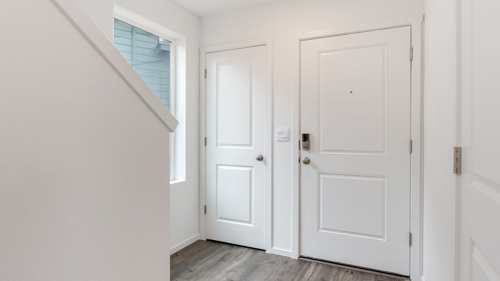 Entryway with a coat closet and laminate flooring