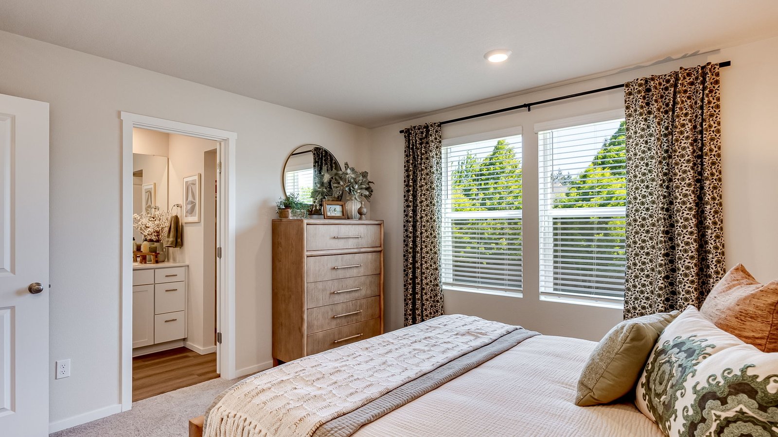 Primary bedroom with wall-to-wall carpet, a walk-in closet and an attached bathroom