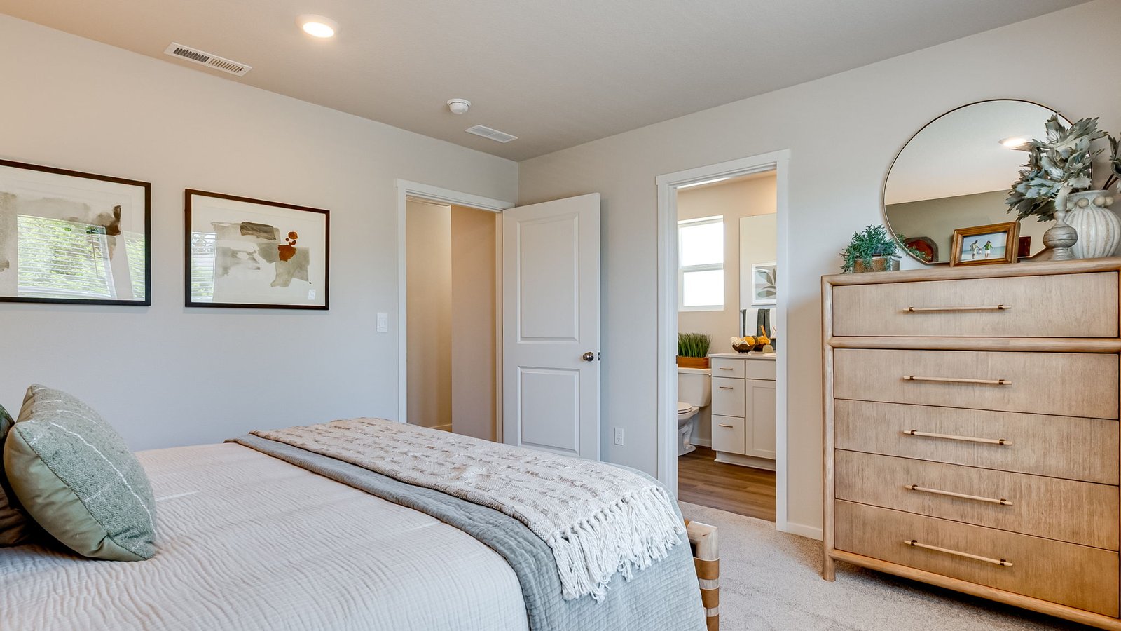Primary bedroom with wall-to-wall carpet, a walk-in closet and an attached bathroom