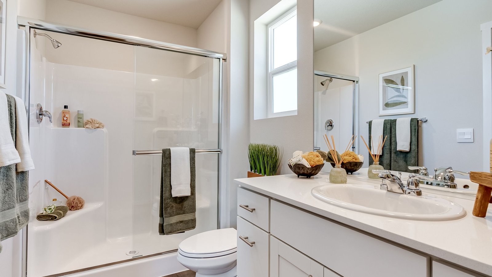 Primary bathroom with quartz counters and a walk-in shower