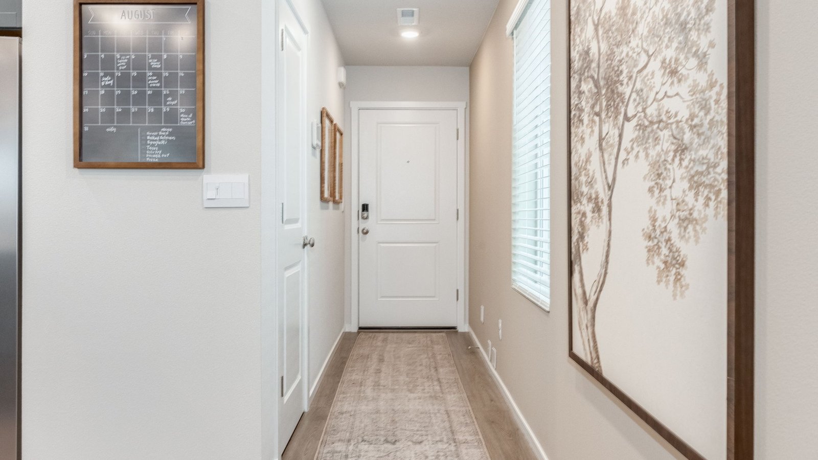 Entryway with a coat closet and laminate flooring
